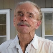 Man with a salt-and-pepper mustache and thinning hair